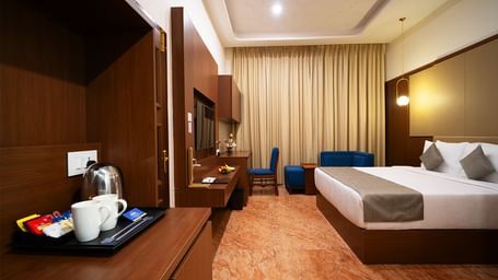 An image of our Superior King Room with a king size bed, a tea/coffee maker, a television and cosy furniture - Accord Chrome Airport Hotel